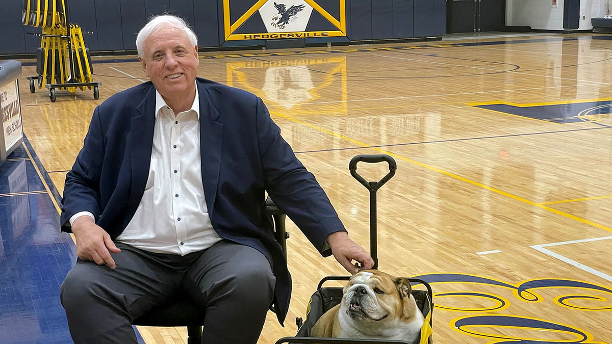 Jim Justice on basketball court with Babydog
