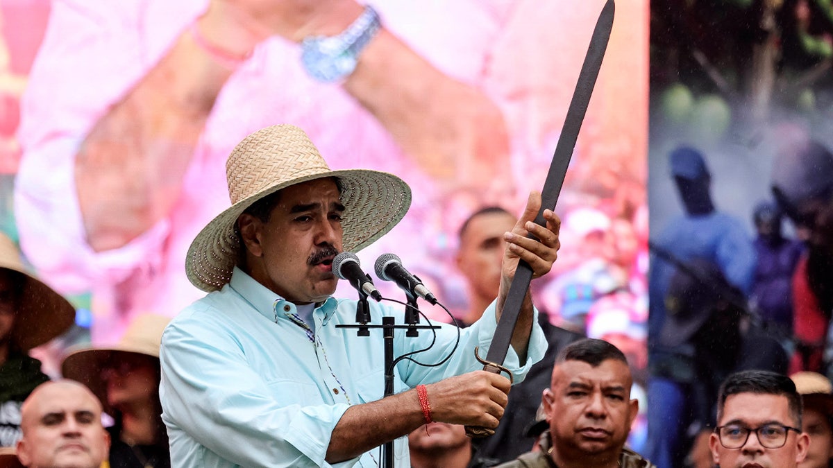 Maduro holding sword at festival