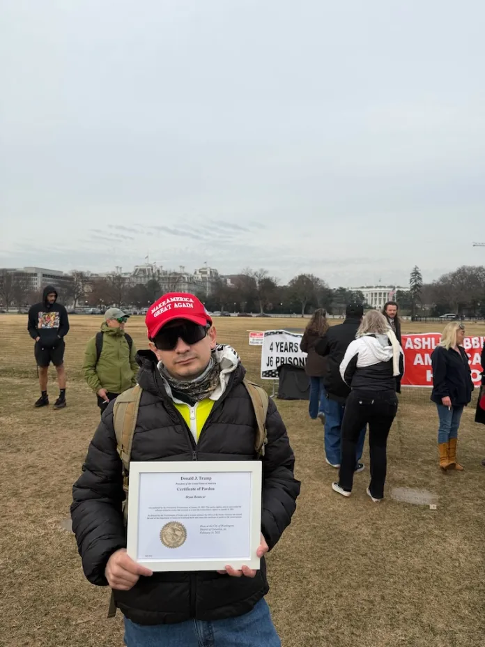Bryan Betancur holds up his pardon from President Donald Trump at the Ellipse in Washington, D.C., on Jan. 6, 2026. (Sydney Topf/Washington Examiner)