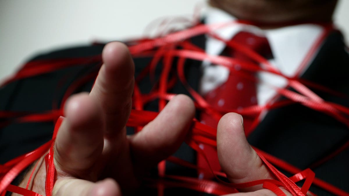 Image of man wrapped in red tape