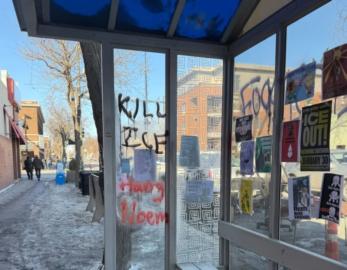 Graffiti on a bus stop feet away from where Alex Pretti was killed by federal law enforcement. (Anna Giaritelli / Washington Examiner)