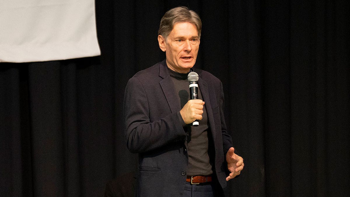 Tom Malinowski talking on stage at a meet and greet hosted by The League of Women Voters at Caldwell University.