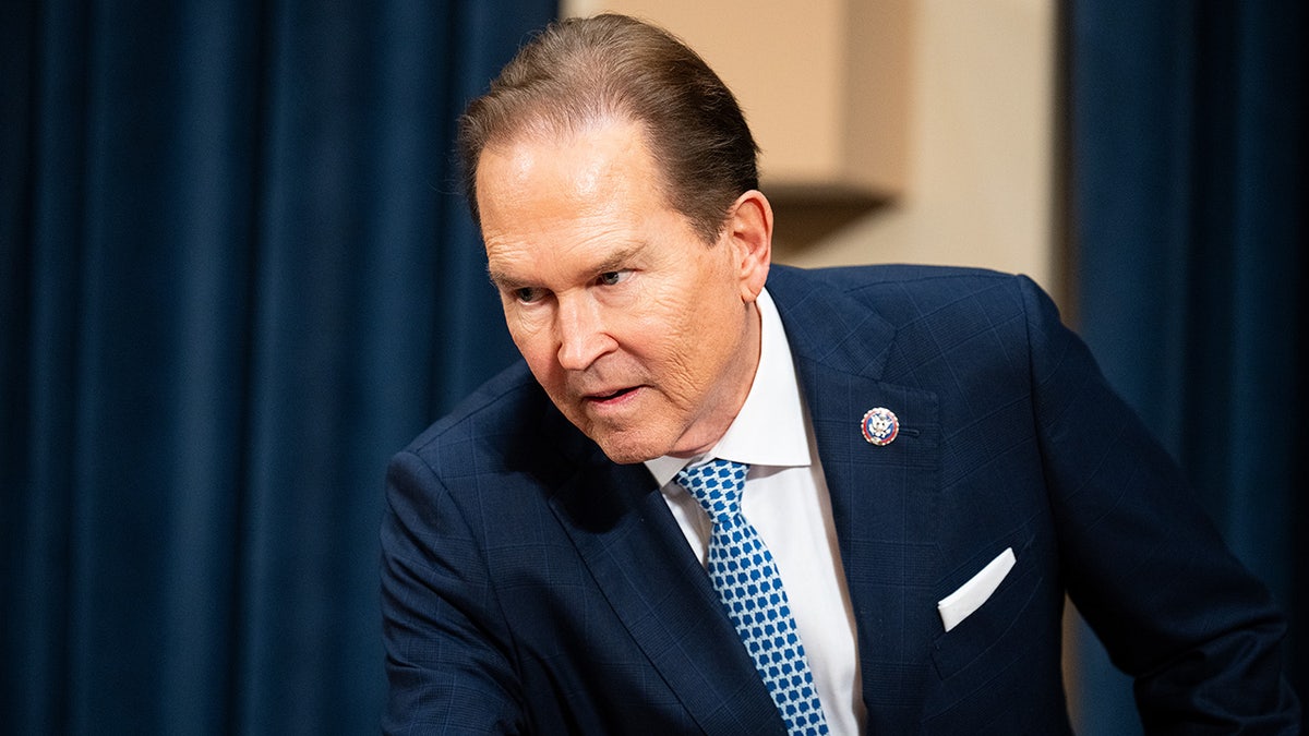 Congressman Vern Buchanan leans over a desk.