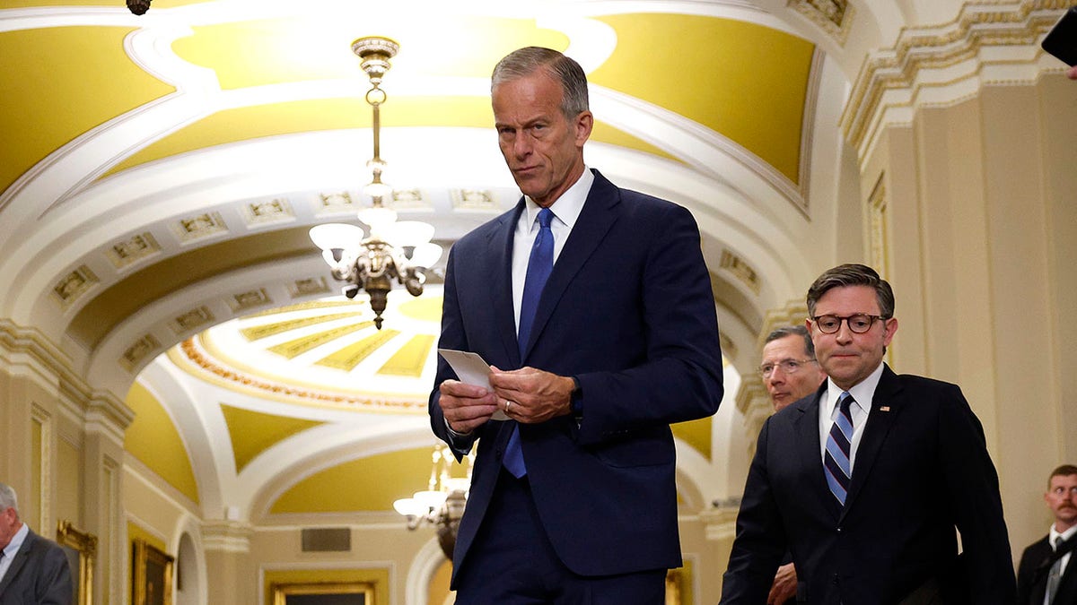 Senate Majority Leader John Thune, R-S.D., and House Speaker Mike Johnson, R-La., walk to a press conference in the Senate.