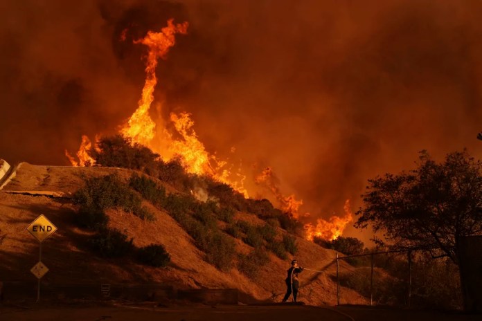 A firefighter battles the Palisades fire.