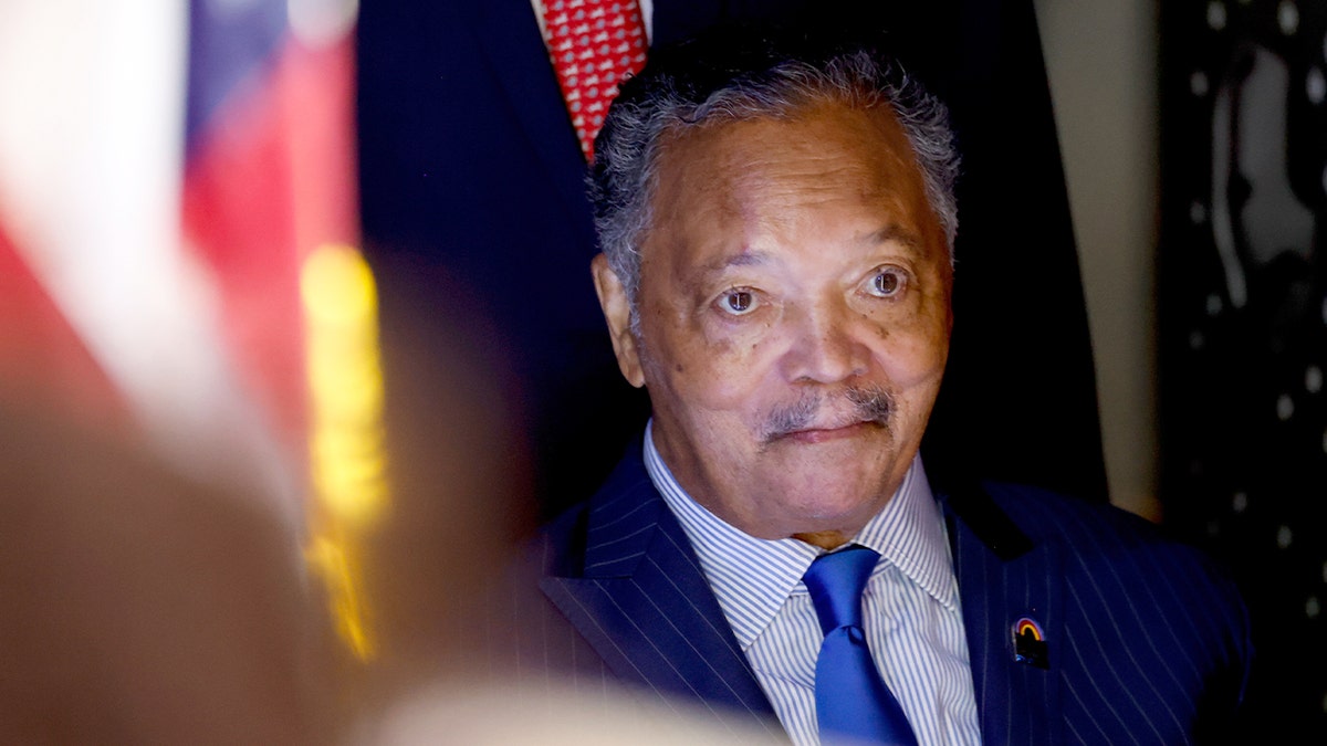 Rev. Jesse Jackson attends the Democratic National Convention in Chicago surrounded by delegates and attendees.