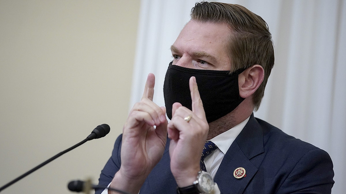 Rep. Eric Swalwell, D-Calif., wears a mask during a congressional hearing on Capitol Hill.