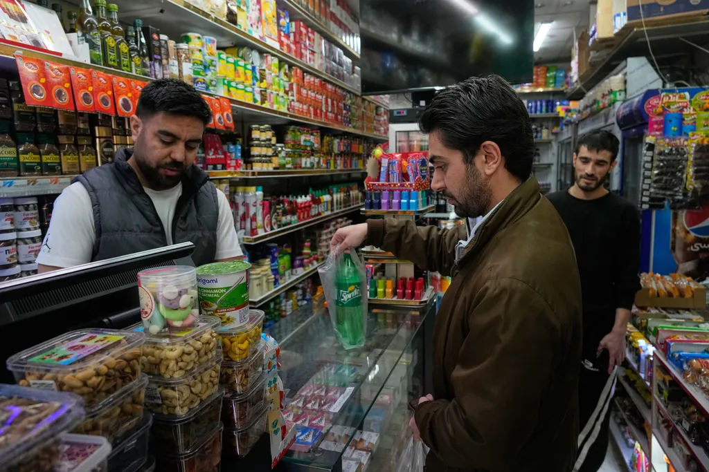 A man shops for soda at a grocery store in northern Tehran, Iran, Tuesday, Jan. 6, 2026.