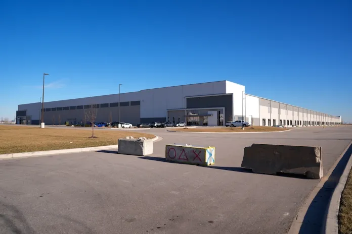 Barricades block a drive outside a warehouse as federal officials tour the facility to consider repurposing it as an ICE detention facility Thursday, Jan. 15, 2026, in Belton, Mo. (AP Photo/Charlie Riedel)