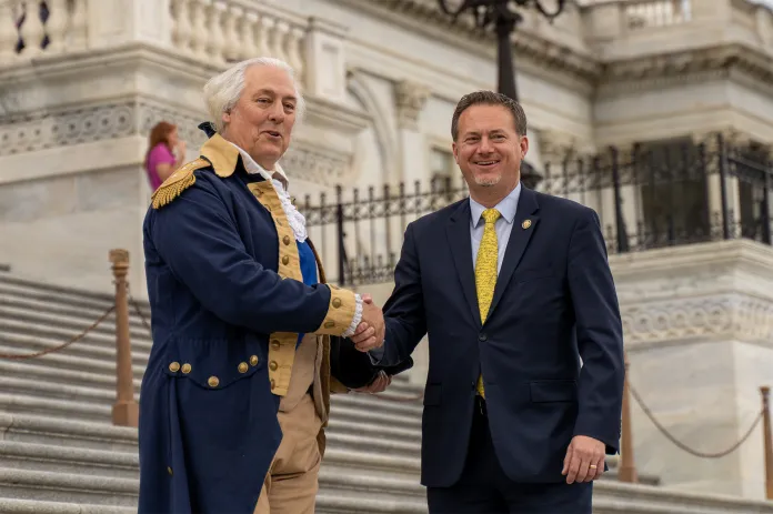 Rep. Michael Cloud (R-TX) shakes hands with his constituent and friend Mark Collins, a George Washington impersonator.