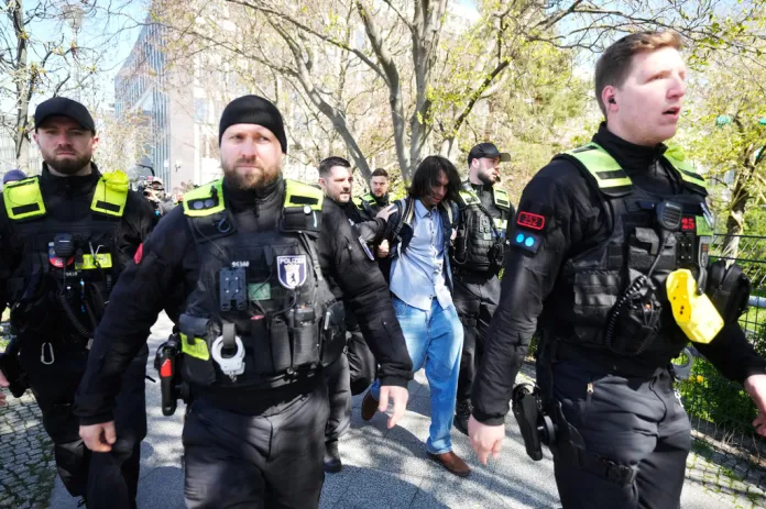 A suspect is dragged away by police