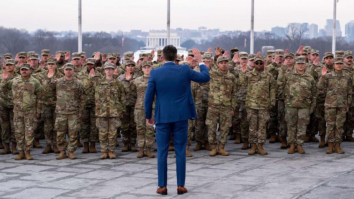 Defense Secretary Pete Hegseth administering oath of enlistment to National Guard soldiers at Washington Monument