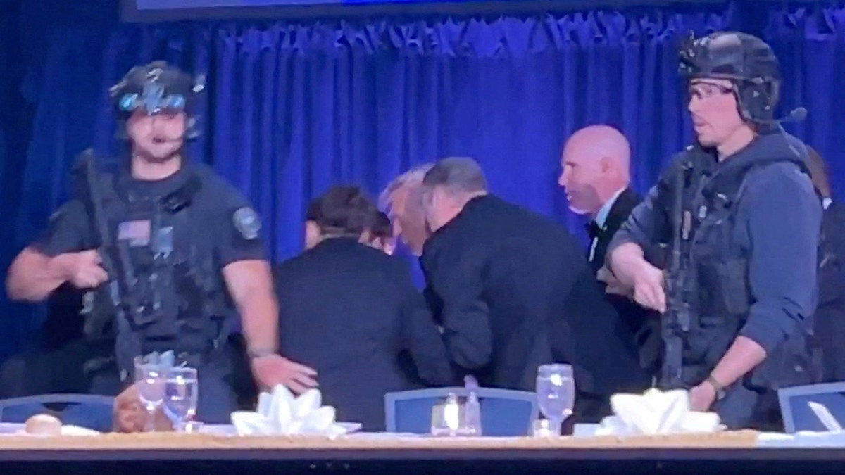U.S. President Donald Trump being escorted out during White House Correspondents' Association dinner