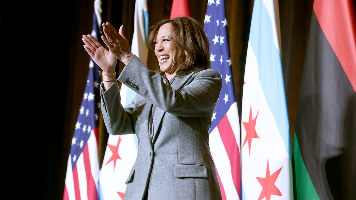 Former Vice President Kamala Harris walking through a hotel ballroom toward a stage