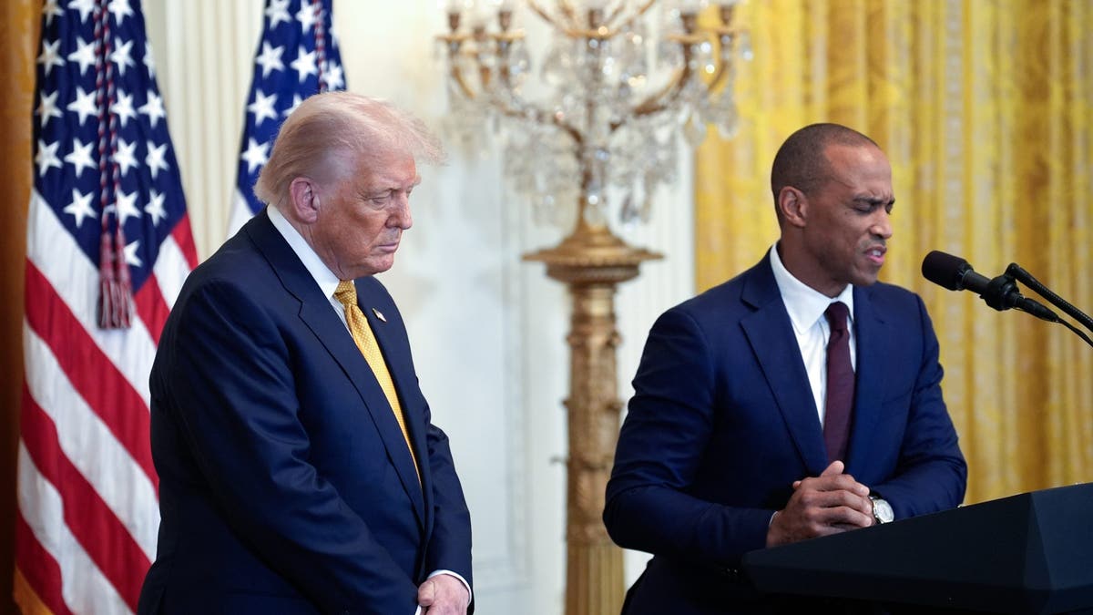 President Donald Trump and Eric Scott Turner standing together in the East Room of the White House.