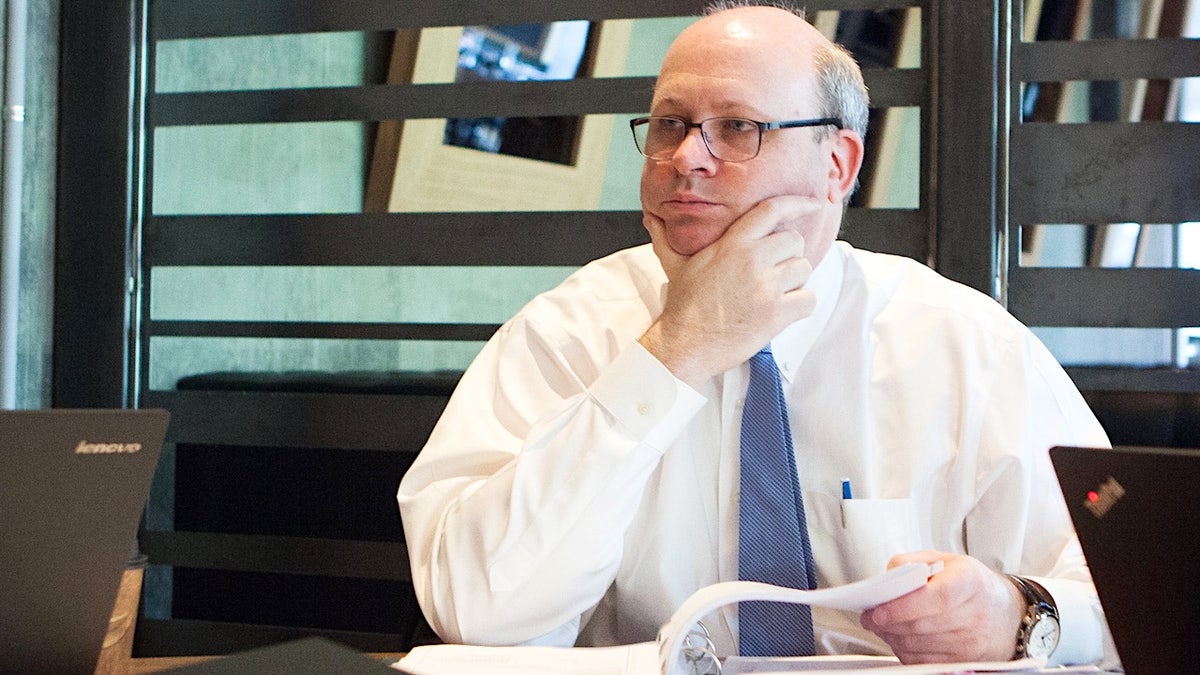 Marc Elias holds his chin in his left hand