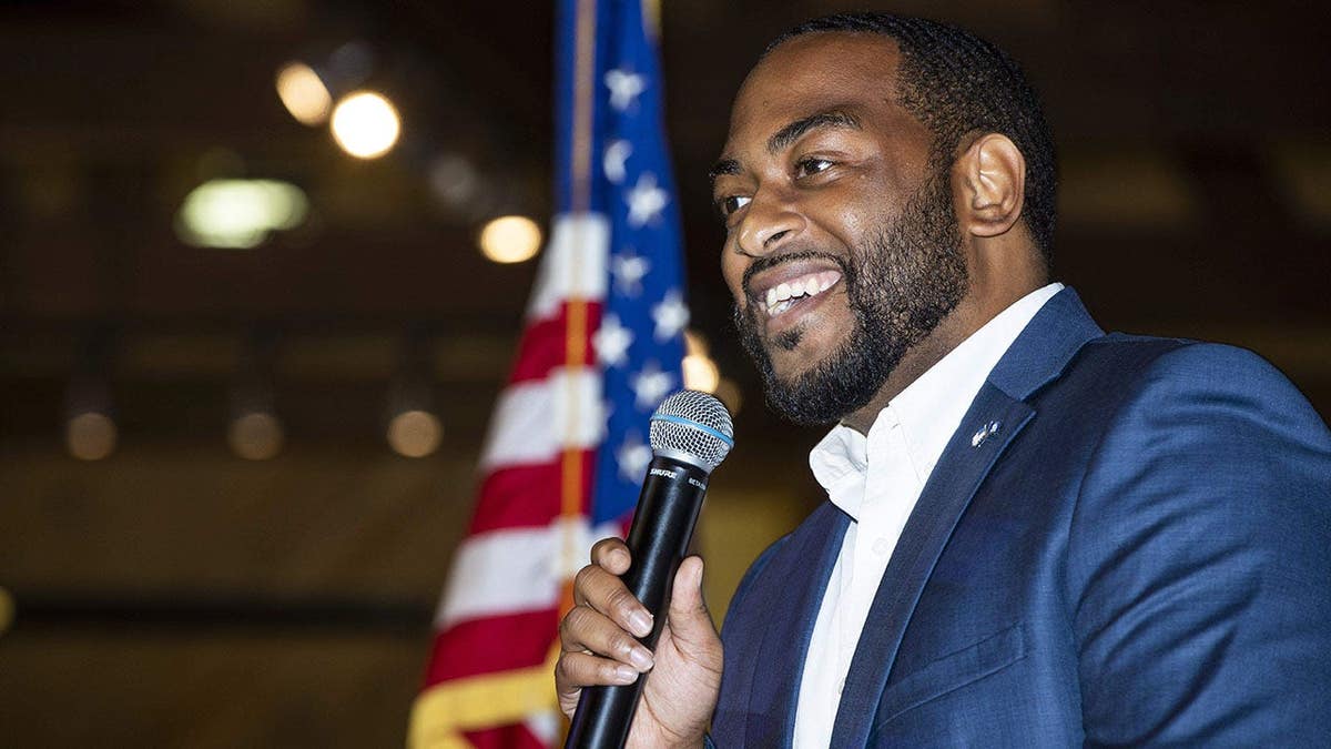 Charles Booker speaking at a podium during the Marshall County Democrats bean dinner in Lexington, Kentucky