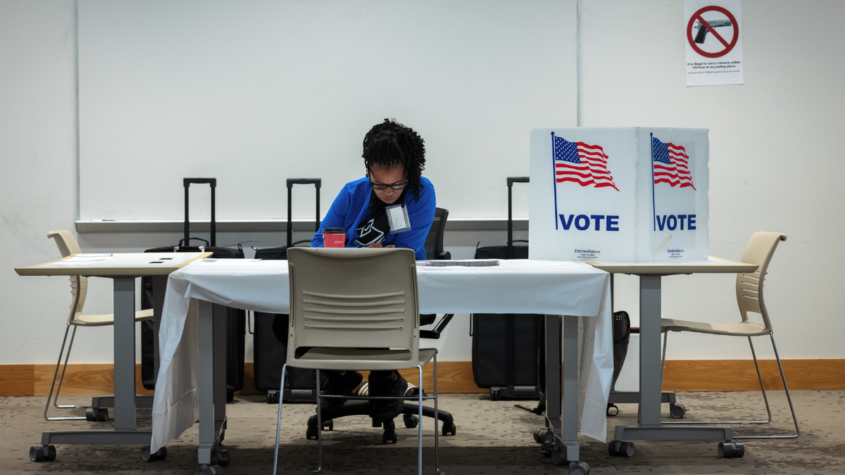 A poll worker prepares to open polls inside Metropolitan Library in Atlanta, Georgia, US, on Tuesday, May 19, 2026.
