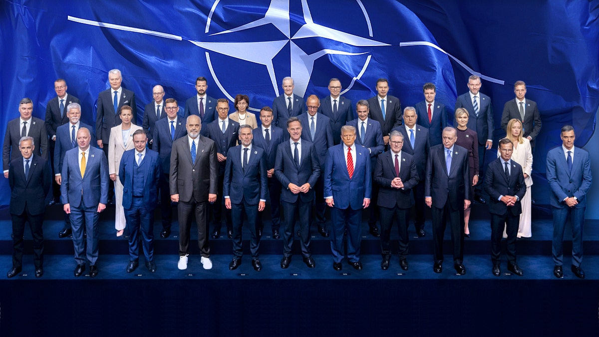 NATO leaders seated at a conference table during a summit in The Hague