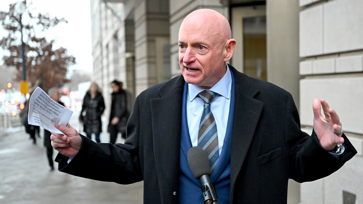 Sen. Mark Kelly speaking to media outside federal court in Washington D.C.