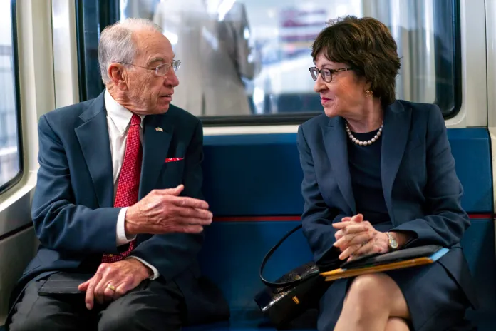 Sen. Chuck Grassley, R-Iowa, and Sen. Susan Collins, R-Maine, talk on the subway on Capitol Hill in Washington, Thursday, Nov. 4, 2021