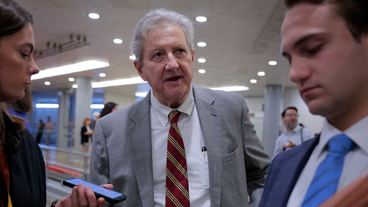 Sen. John Kennedy walking through the basement of the U.S. Capitol talking to reporters