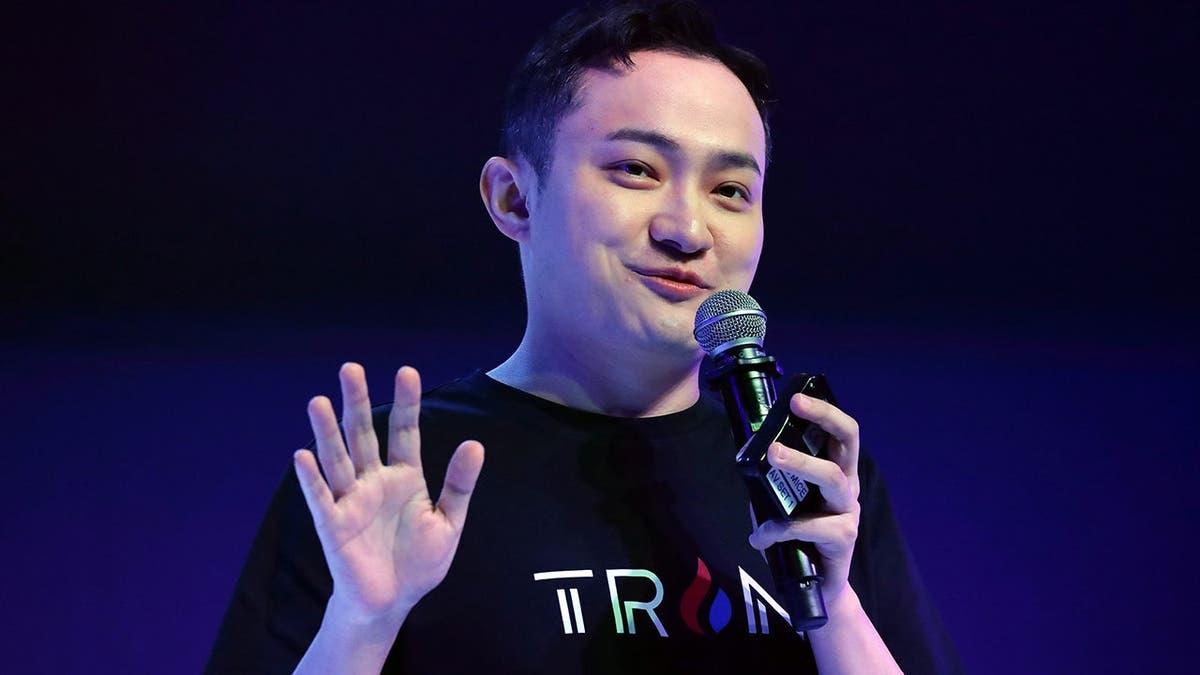 Justin Sun seen holding a microphone