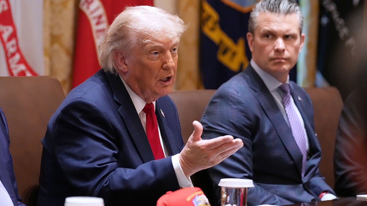 President Donald Trump speaking during a Cabinet meeting with Secretary of War Pete Hegseth looking on