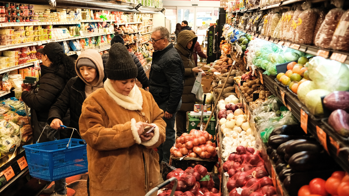 People shop at a local supermarket in New York City.