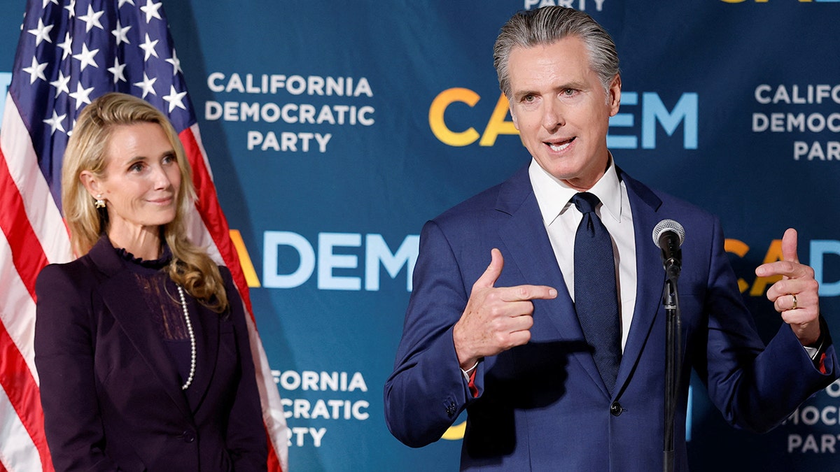 California Gov. Gavin Newsom speaking next to his wife Jennifer Siebel Newsom at California Democratic Party Headquarters in Sacramento