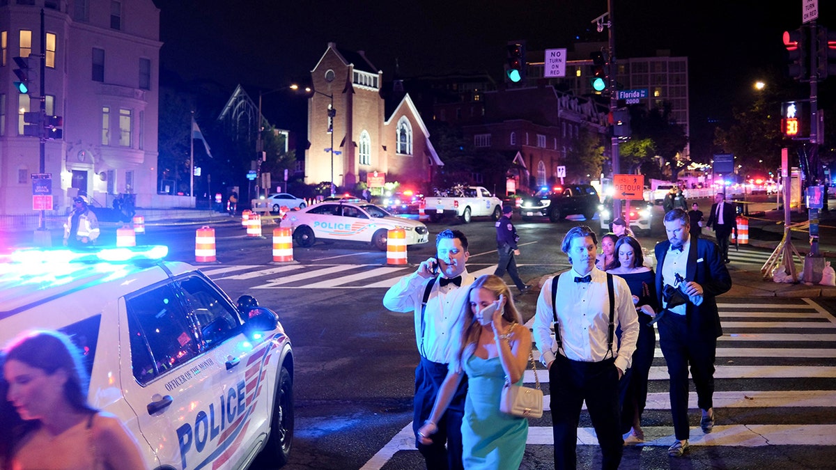 Guests walking away from the Washington Hilton amid heavy police presence