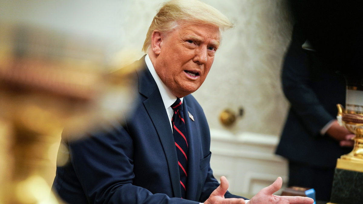 President Donald Trump talks to reporters during a meeting with Iraqi Prime Minister Mustafa Al-Kadhimi in the Oval Office at the White House.