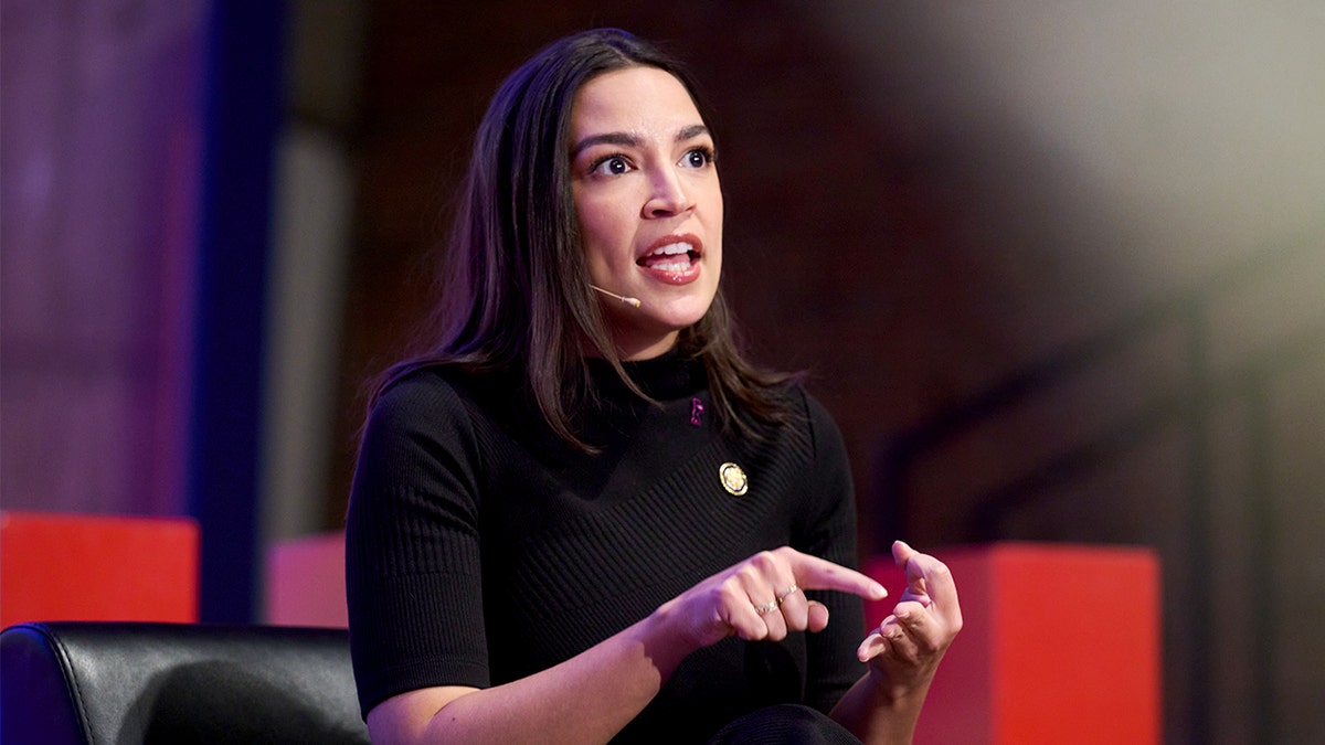 Rep. Alexandria Ocasio-Cortez speaking at TU Berlin podium