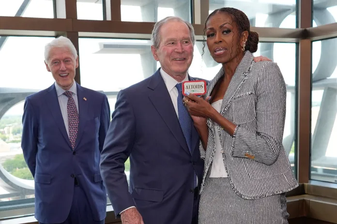 michelle obama and george w bush pose for photos at the presidential center opening