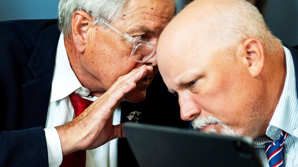 Rep. Ralph Norman and Rep. Chip Roy exchange words in a committee meeting room.