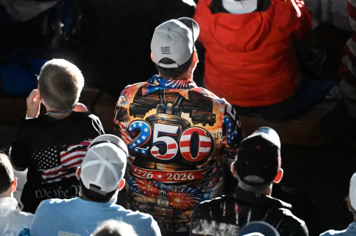 An attendee wearing a 250 shirt listens as President Donald Trump speaks at Mount Rushmore National Memorial, Friday, July 3, 2026, near Keystone, S.D.