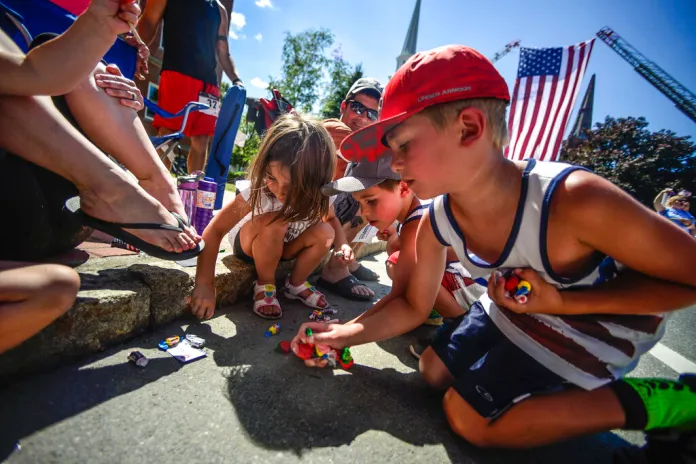 Children rush to grab candy during the annual Fourth of July parade in downtown Brattleboro, Vt., Monday, July 4, 2016. (Kristopher Radder/The Brattleboro Reformer via AP)