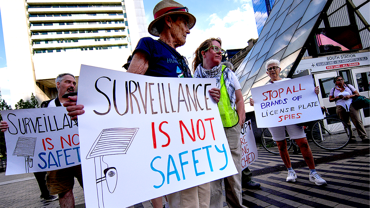 Protesters march against Flock Safety license plate cameras in Boston.