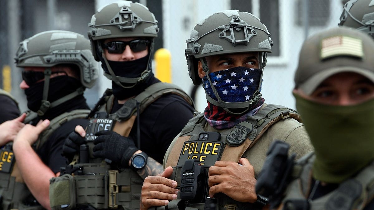 Immigration and Customs Enforcement (ICE) agents stand outside Delaney Hall detention center in Newark, New Jersey.