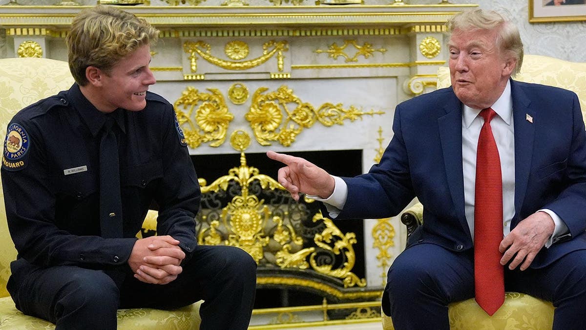 President Donald Trump speaks while meeting with lifeguard Ryder Williams in the Oval Office.