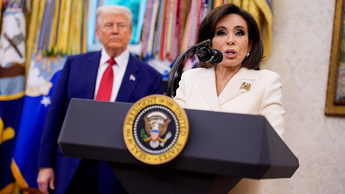 President Donald Trump looks on as Jeanine Pirro speaks during her swearing-in ceremony in the Oval Office.