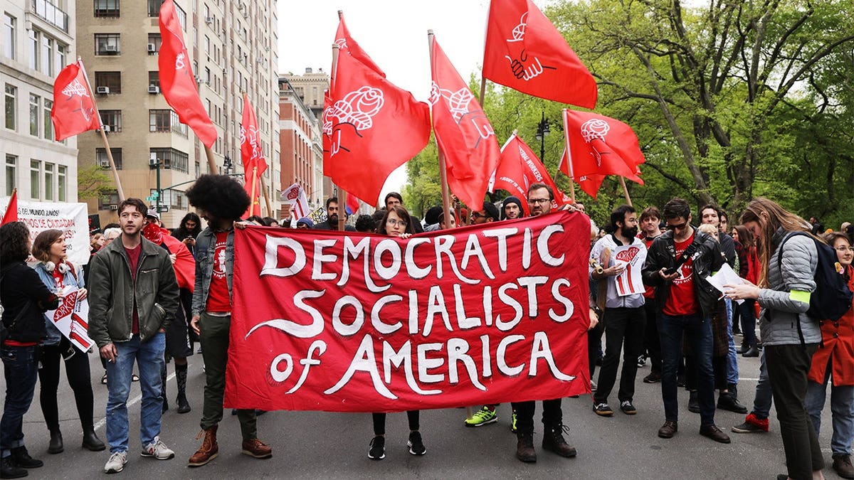 Members of the Democratic Socialists of America gather outside a Trump-owned building in New York City.