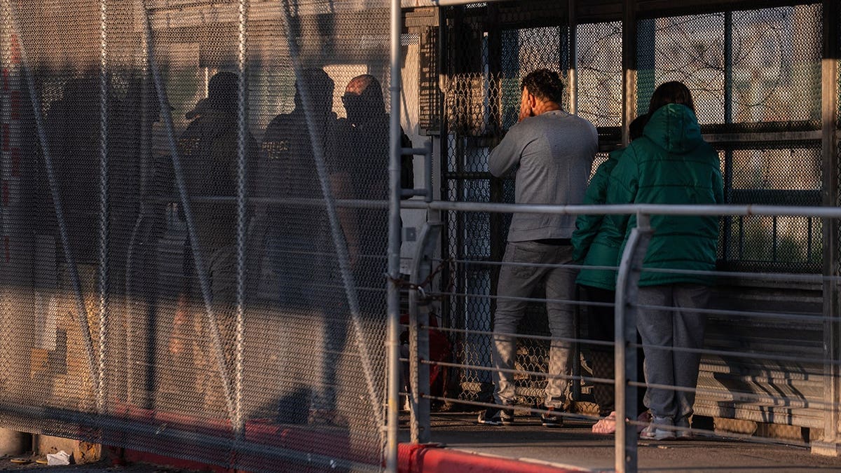 ICE agents escort undocumented migrants across the McAllen-Hidalgo-Reynosa International Bridge.