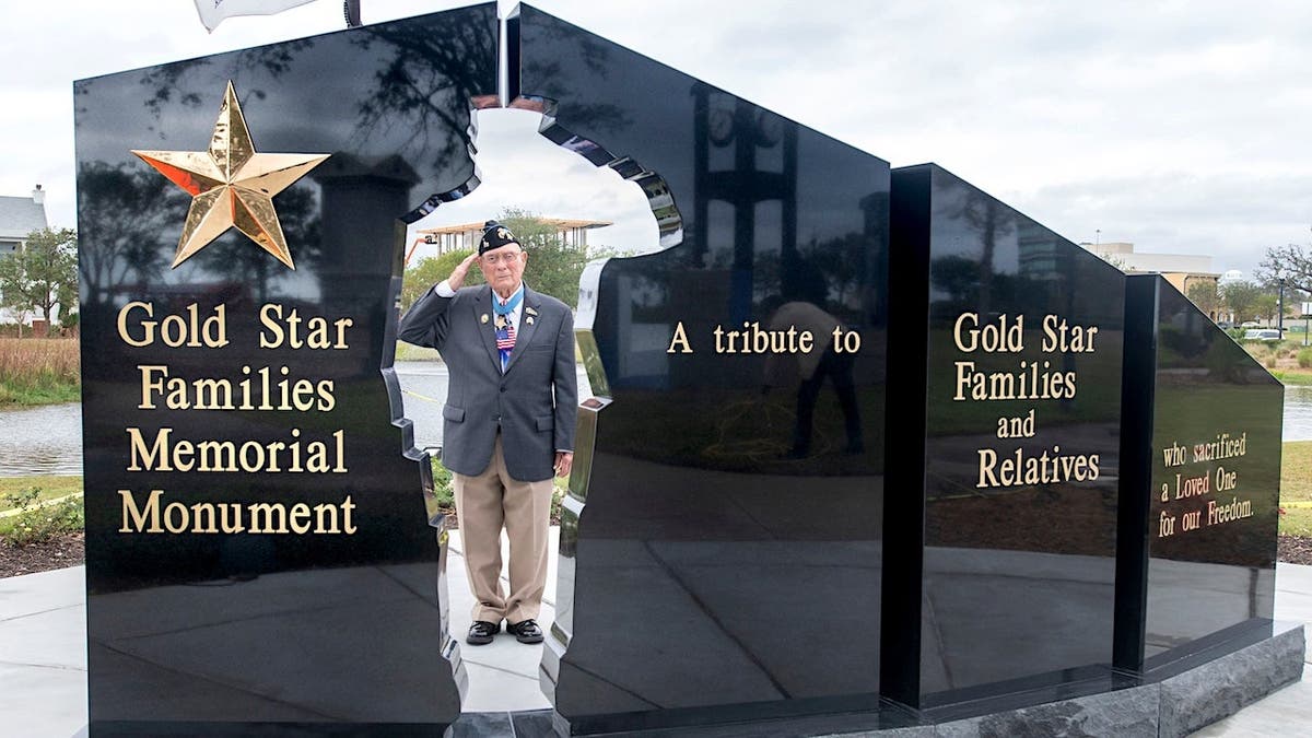 Hershel Woody Williams salutes at Gold Star Families Memorial Monument.