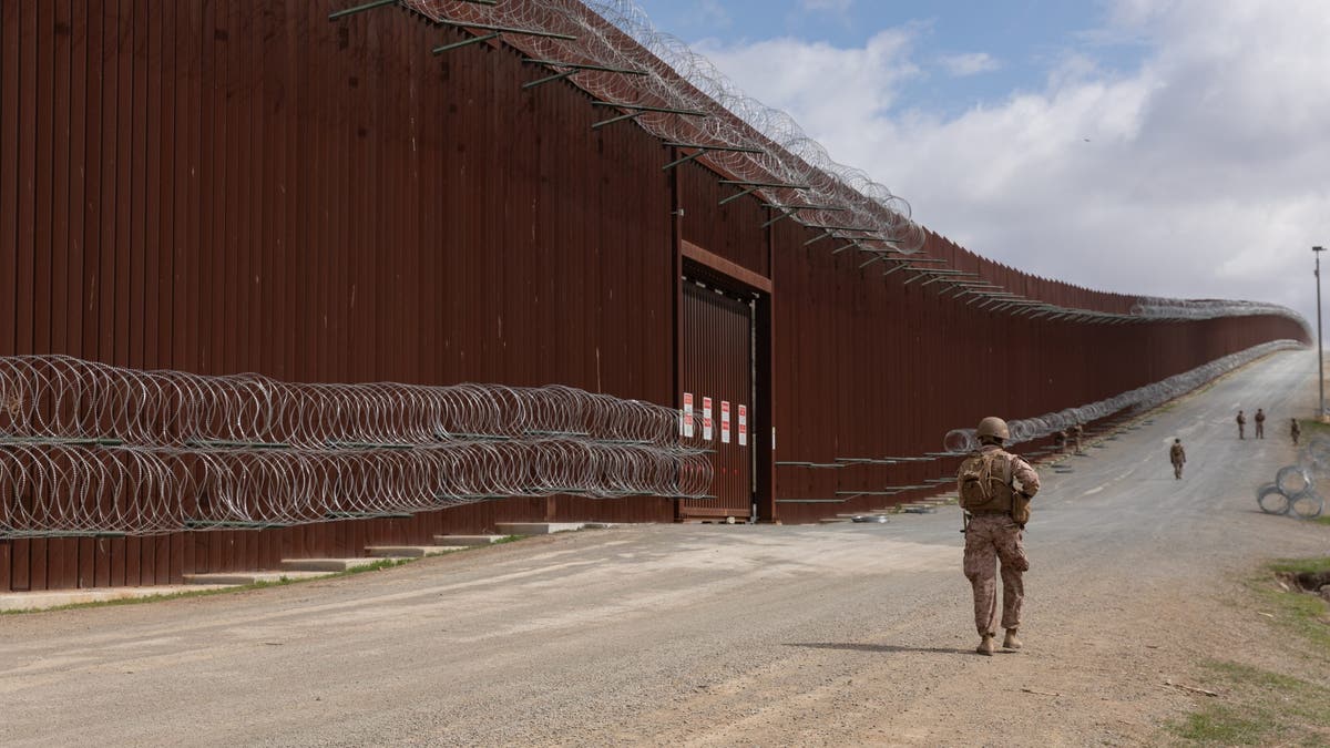 U.S. Marines with 1st Combat Engineer Battalion, 1st Marine Division, affix concertina wire to engineer stakes on the barrier along the southern border near San Ysidro, Calif., Mar. 2, 2025. U.S. Northern Command is working together with the Department of Homeland Security to augment U.S. Customs and Border Protection along the southern border with additional military forces. (U.S. Army photo by Pfc. Dominic Atlas)