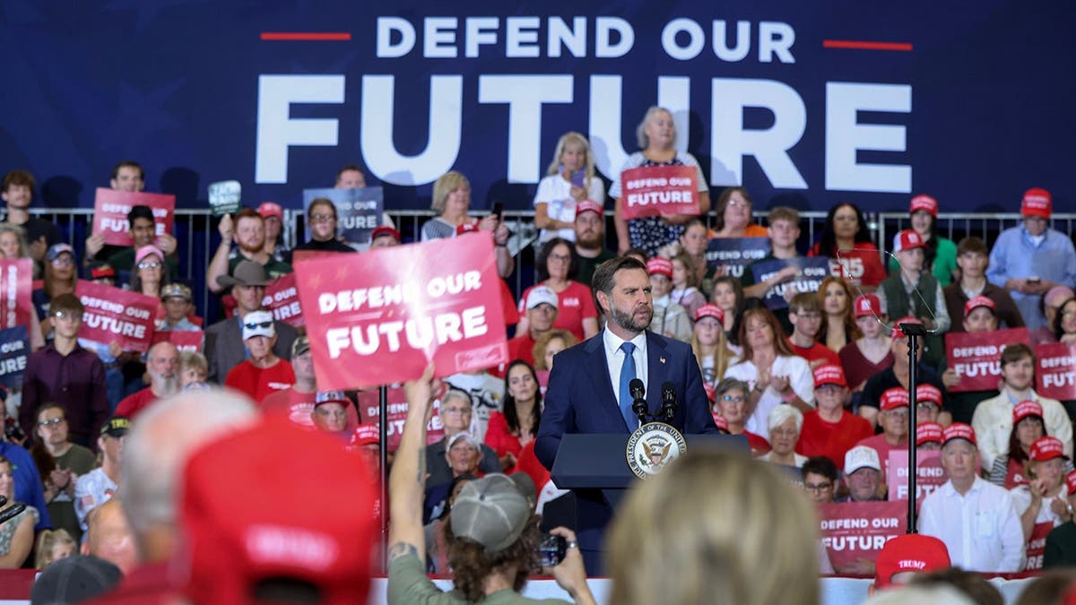 Vice President JD Vance speaks at a podium during a Republican National Committee rally.