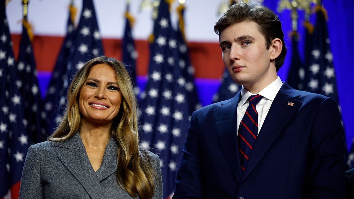 Former President Donald Trump speaking at election night event with Melania and Barron Trump in West Palm Beach.