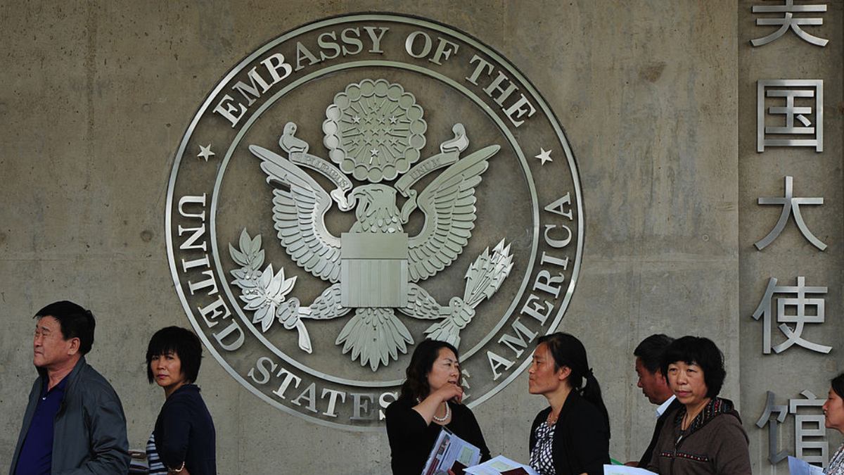 Chinese citizens wait to submit their visa applications at the US Embassy.
