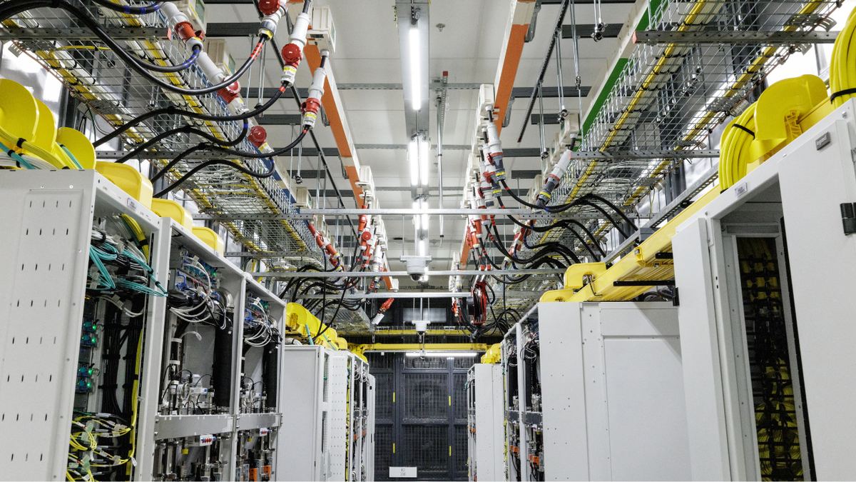 Racks of graphics processing units (GPUs) with a closed-loop liquid cooling system are seen inside an operational Microsoft data center.