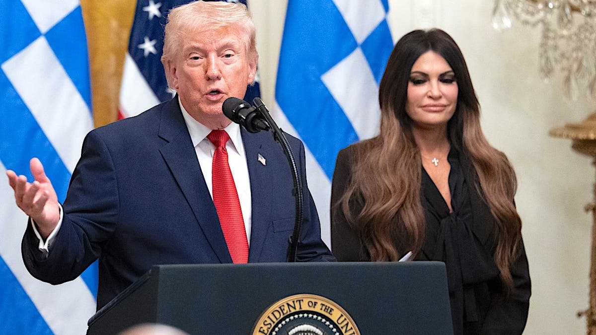 President Donald Trump stands with Kimberly Guilfoyle during a Greek Independence Day celebration in the East Room.